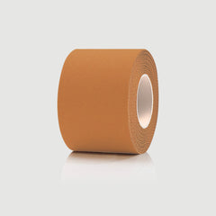 Roll of brown kinesiology tape on a light gray background