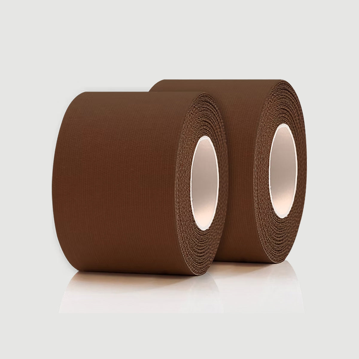 Two rolls of brown tape on a light gray background