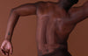Partial view of a person with a brown background