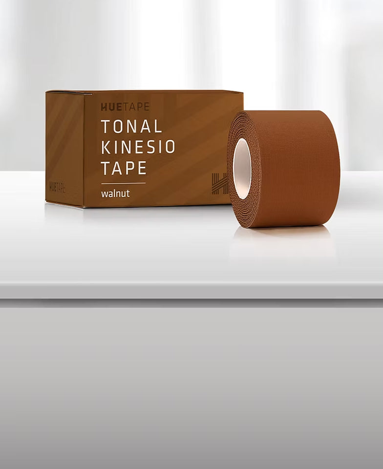Brown kinesiology tape with packaging on a white surface