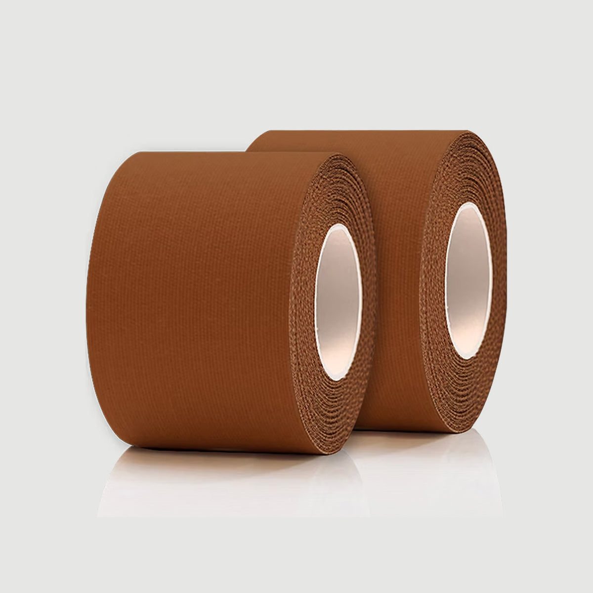 Two rolls of brown tape on a light gray background