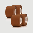 Three rolls of brown tape on a light gray background