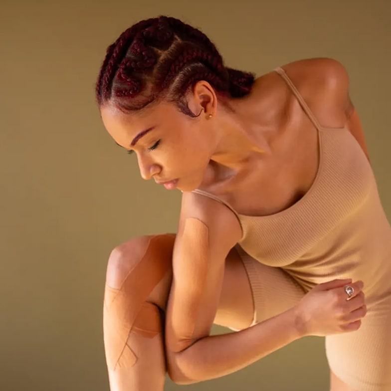 Dancer in a beige leotard against a beige background